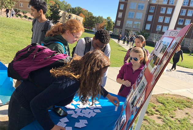 Students on campus attending an outdoor informational fair