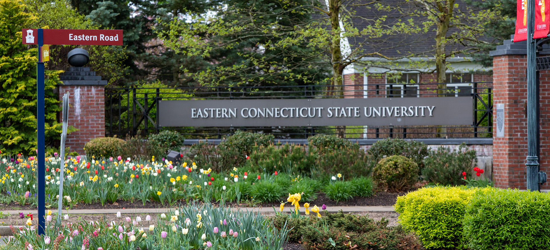 the Eastern sign at the entrance to campus with flowers around it