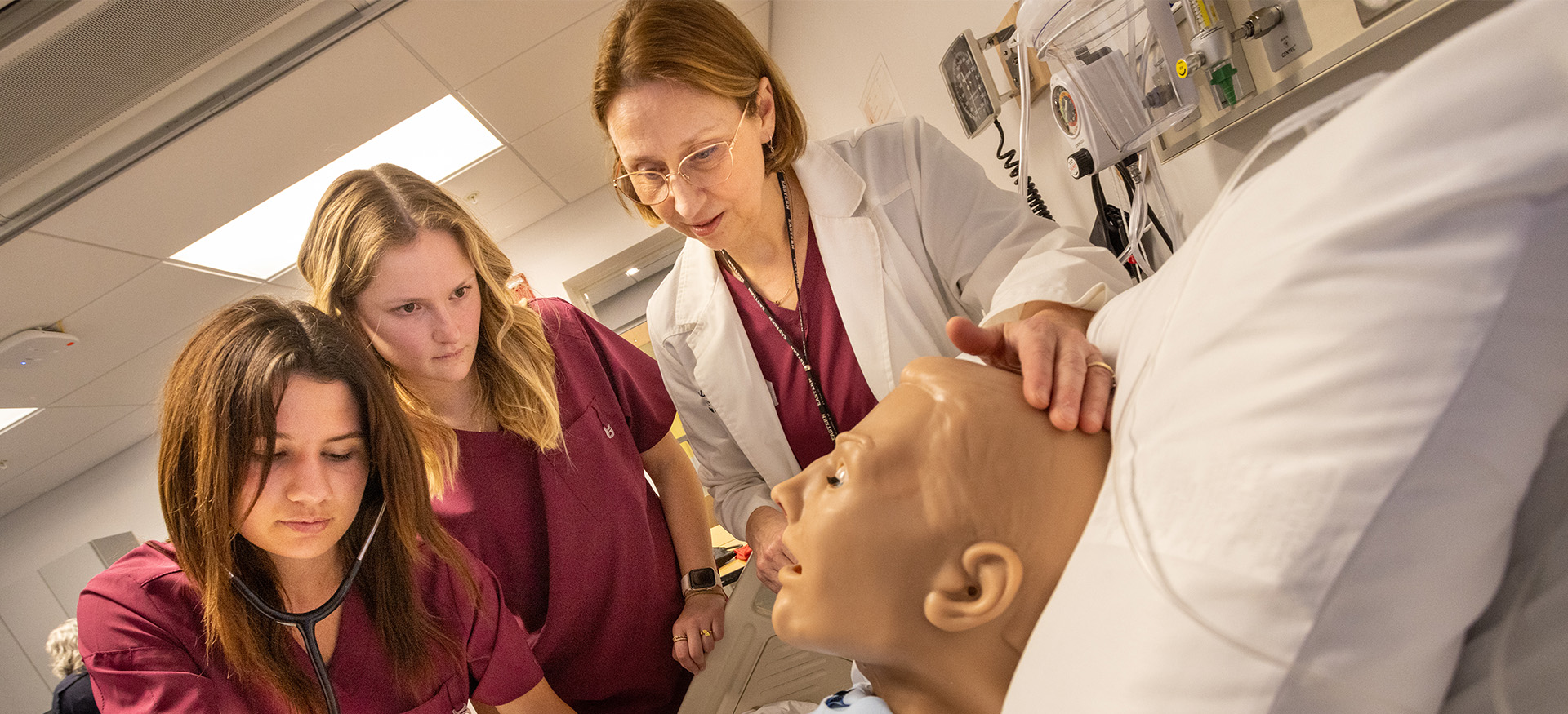 nursing students practicing on a medical dummy