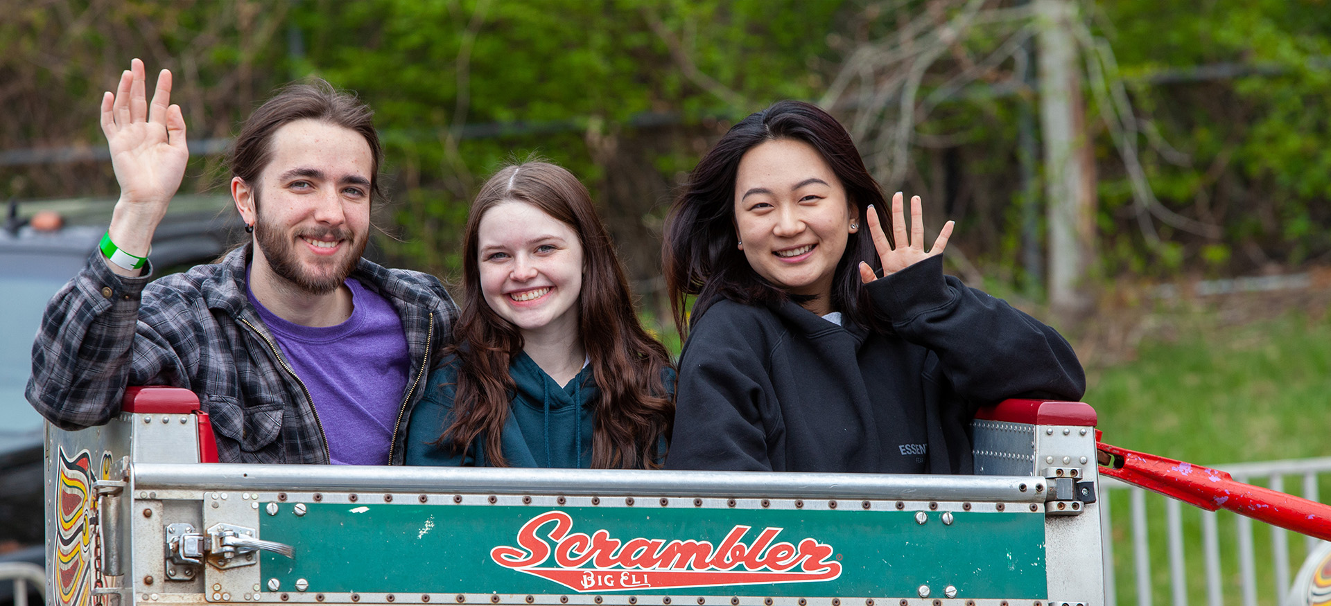 students riding the Scrambler and waving