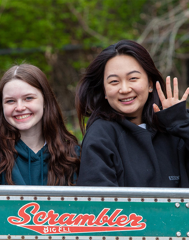 students riding the Scrambler and waving