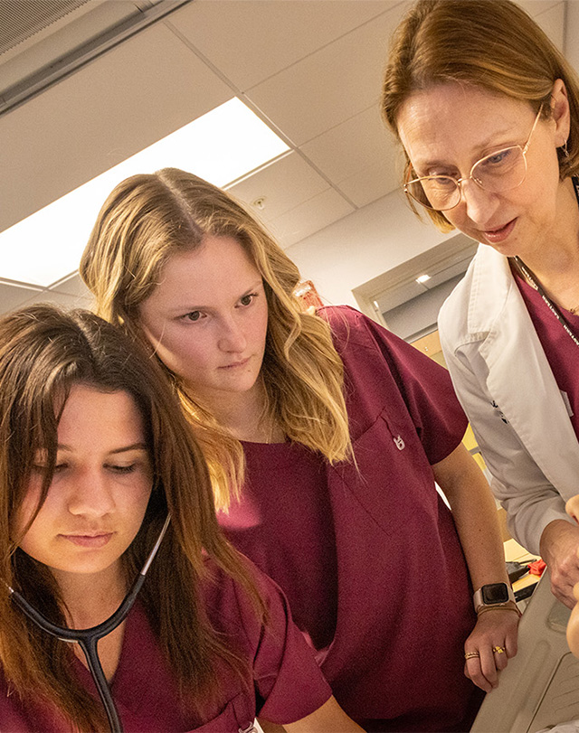 nursing students practicing on a medical dummy