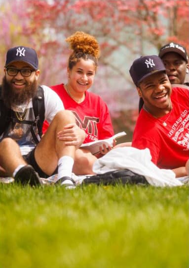 people relaxing on campus