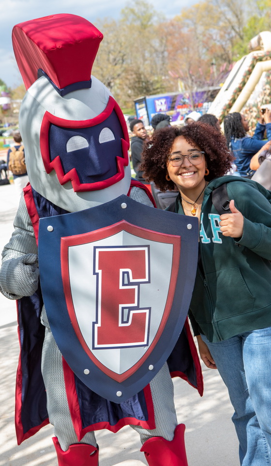 Willi the Warrior and a student waving