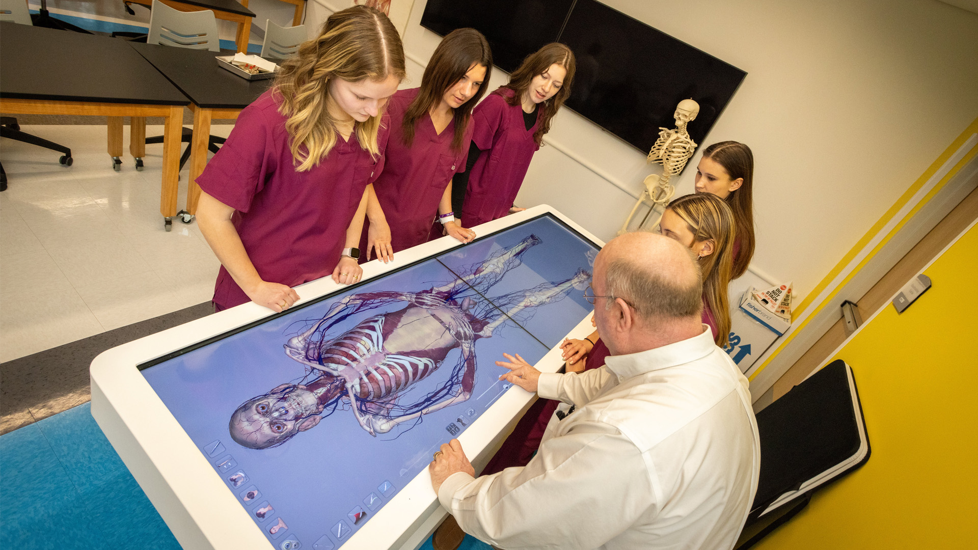 nursing students and professor using virtual dissection table