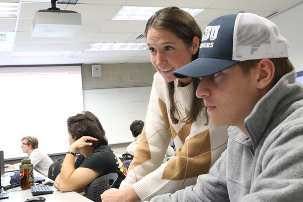 professor working with student on computer