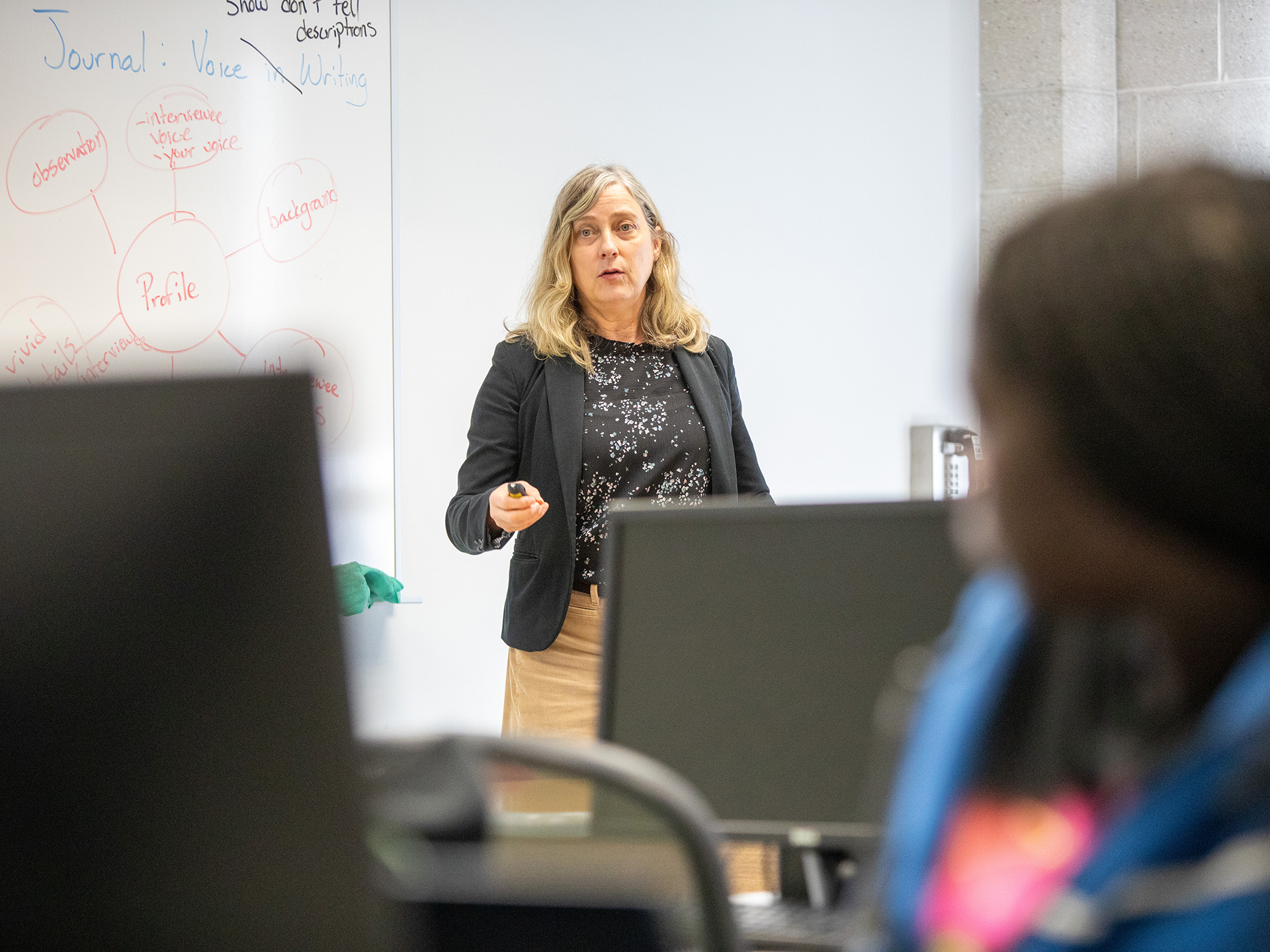 Becki Quick talking to students in front of class