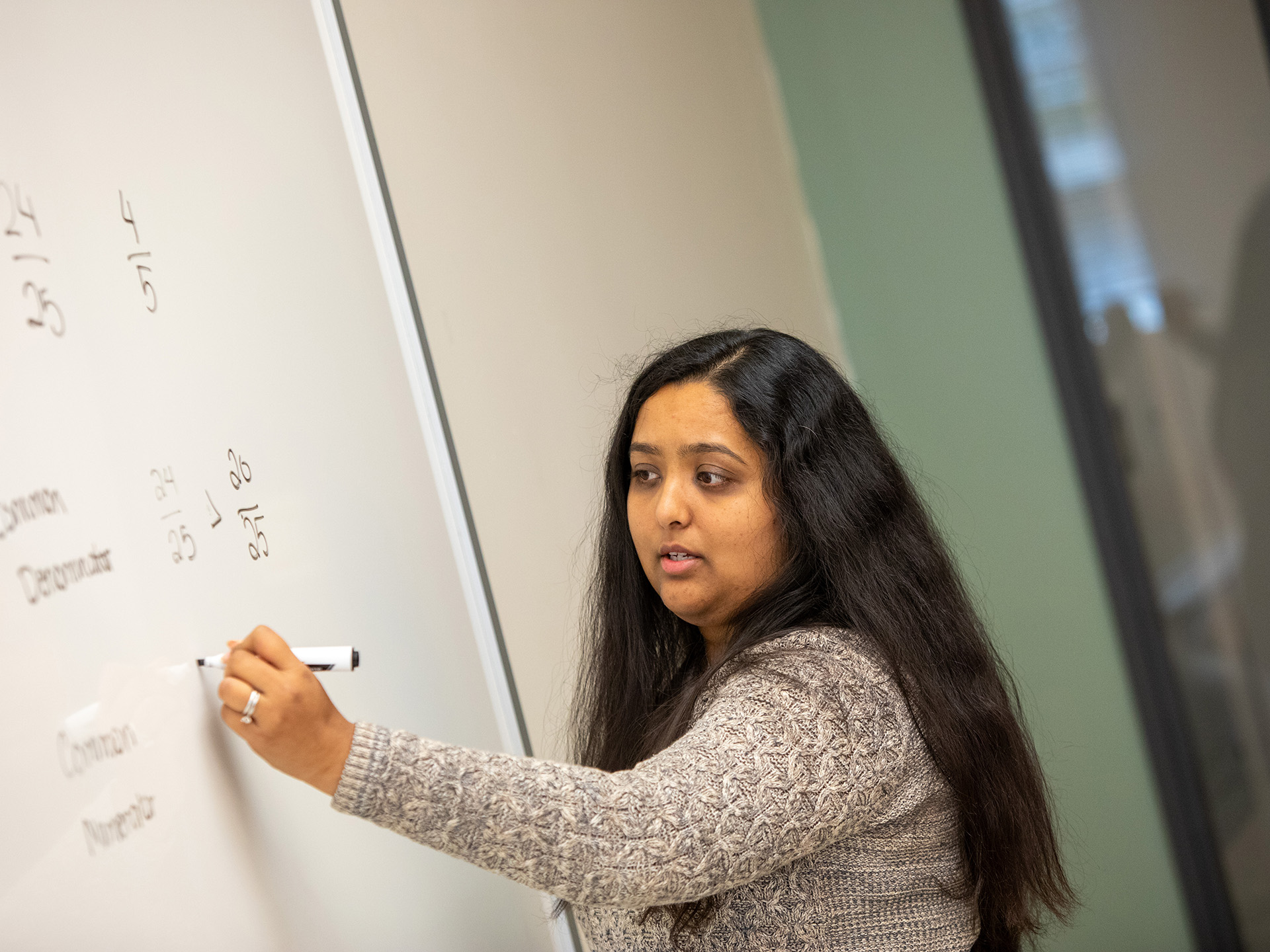 Siddhi Soni writing on a whiteboard