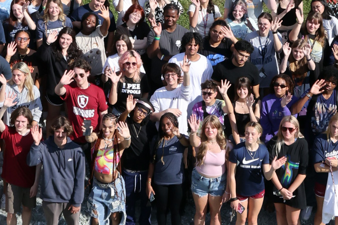 Students waving at the camera