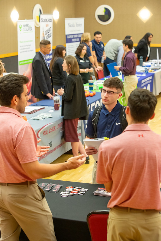 students speak with representatives