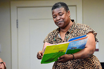 Winsome Bingham holding the book "The Table"