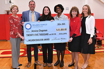 Chapman with check (photo credit: Milken Family Foundation)